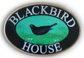Blackbird - The customer ordered two New World classic oval signs for her house. Our artist Jean painted one blackbird facing left and one facing right. The source of the artwork for the bird pictorial was the excellent website site www.birdcheck.co.uk . Font is called Times Roman