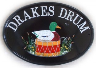 Drakes drum - The customer requested a pictorial of a drake sat on top of a snare drum as if it was nesting. Painted by Jean on a New World classic oval base plaque. Font is called Century Schoolbook