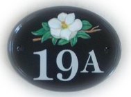 Magnolia flower head - painted on a small classic oval base plaque by Gerry
