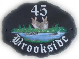 Rabbits by a babbling brook - This pictorial was painted on a large natural oval base plaque. Font is called Old English. Painted by Gerry