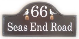 Seagulls - The customer asked for a simple design depicting a seagull either side of the numbner .Painted on a large mews house plaque by Gerry