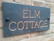 House sign with gold lettering